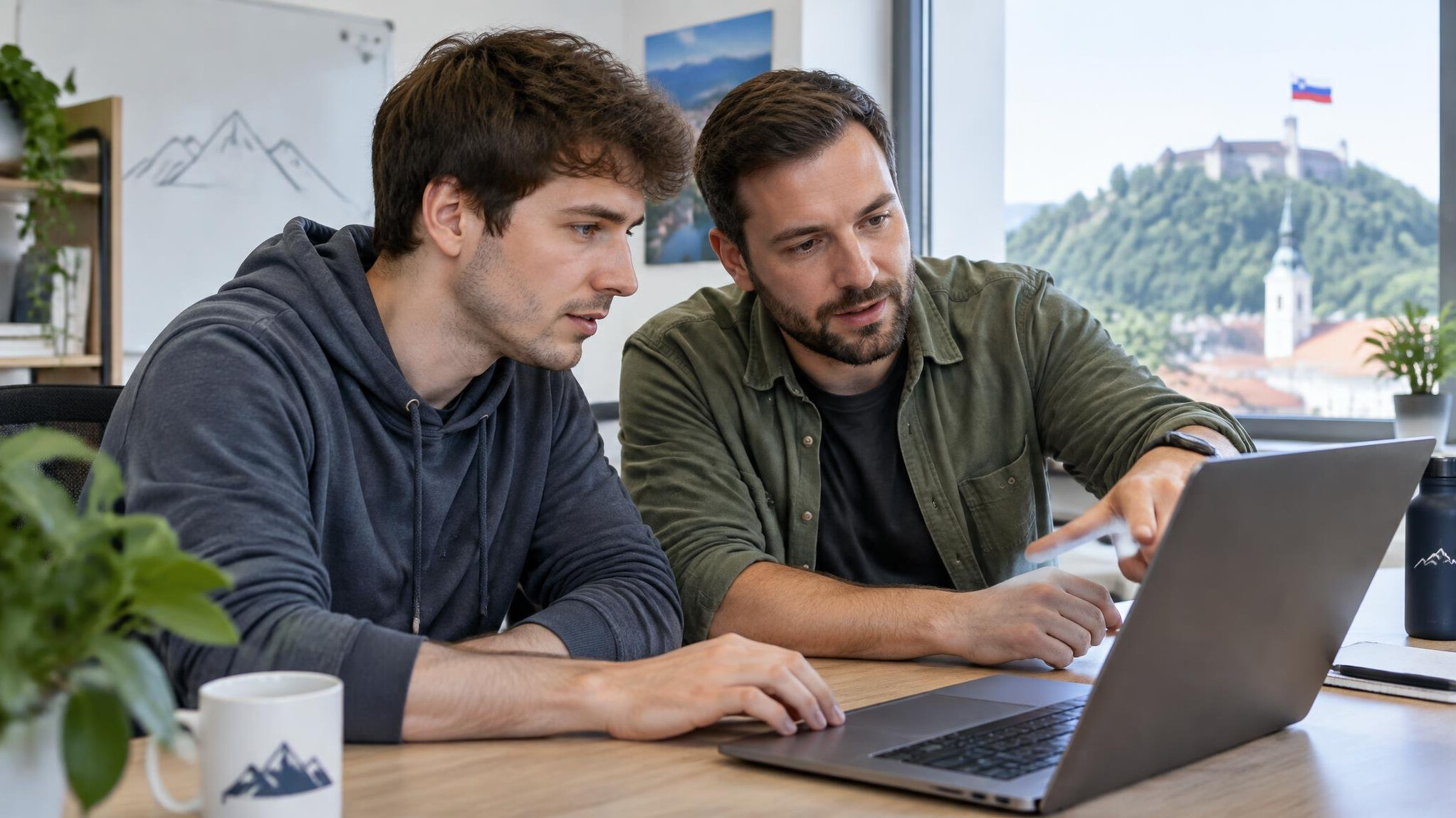 Two developers reviewing code together at a desk